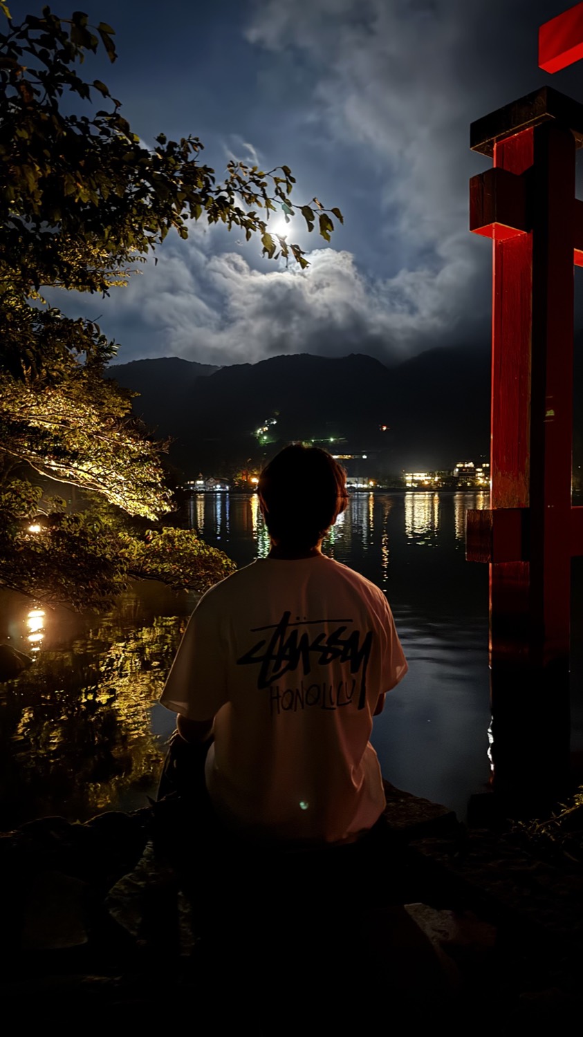 Moonlit lake and shrine at night in Japan