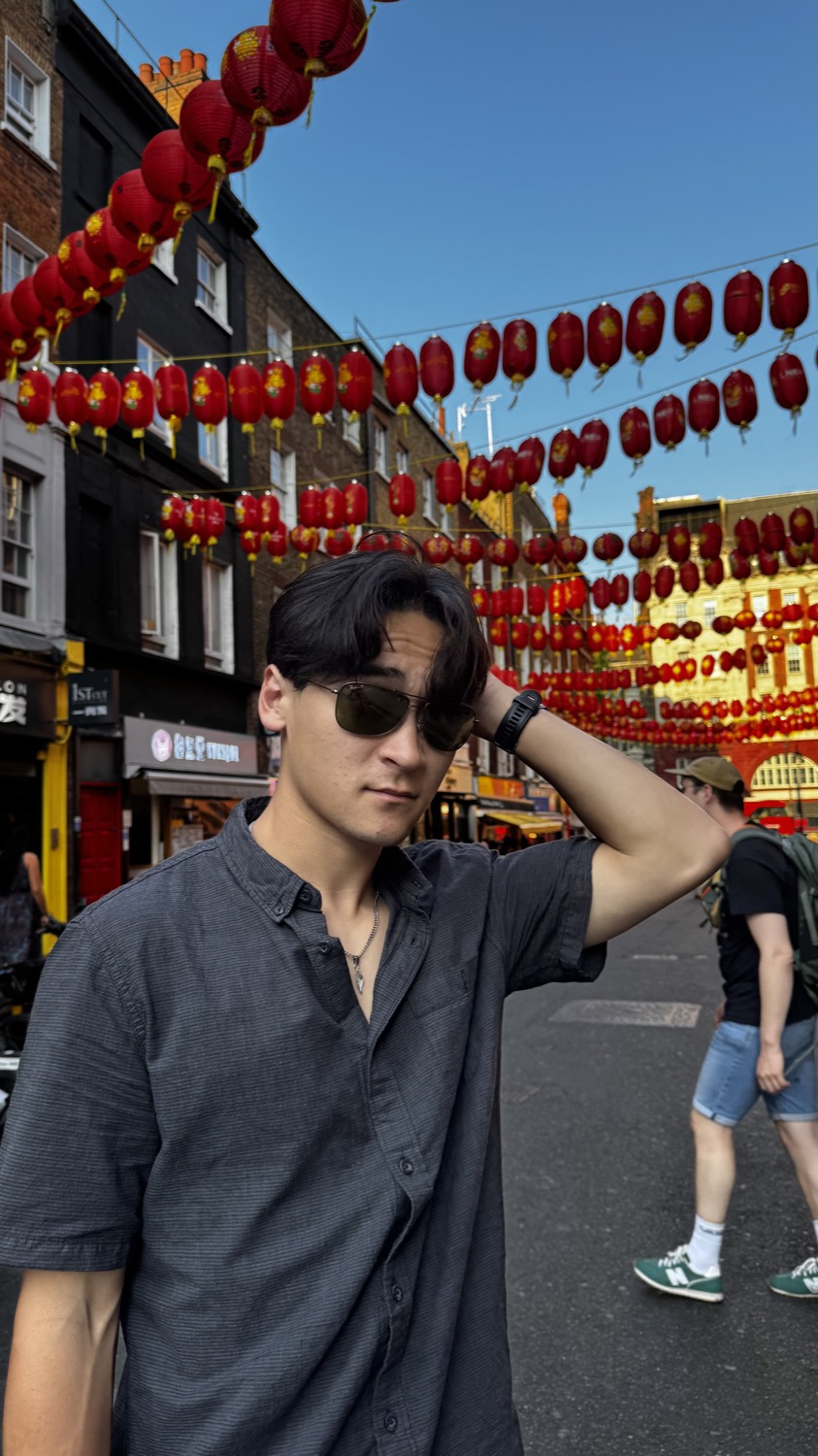 Daniel in London's Chinatown beneath red lanterns